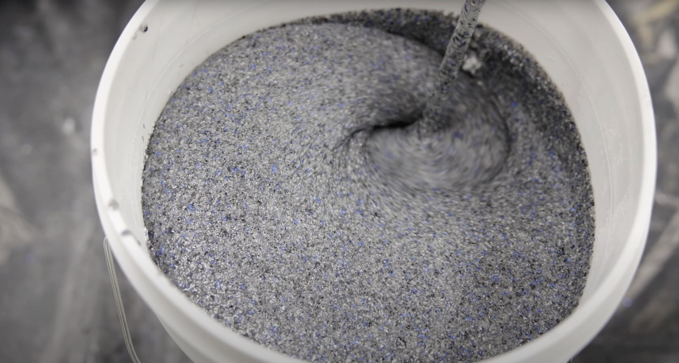 Fresh concrete mix being prepared with proper water ratio